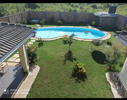 a backyard with a swimming pool in the yard at Lisa in Mombasa