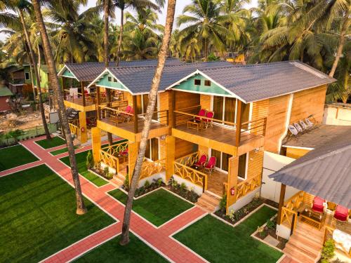 an aerial view of a house with palm trees at The O2H Agonda Beach Resort in Agonda