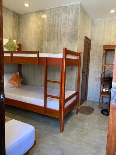 a bedroom with two bunk beds in a room at RL Harbor Inn in El Nido