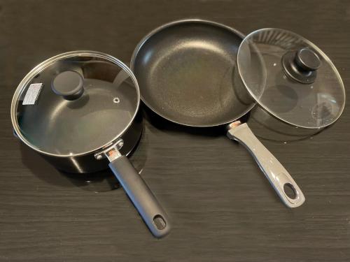 two utensils and a frying pan on a table at belle lune hotel hakata Suite Room 1 in Fukuoka