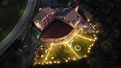 an overhead view of a building with lights at night at Agriturismo Fonte Madonna in Mirto
