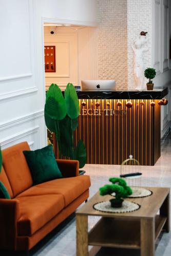 a living room with a couch and a table at Andor Luxury Hotel & Duplex in Durrës