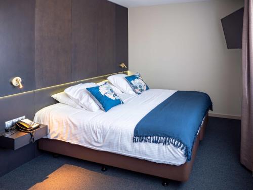 Postel nebo postele na pokoji v ubytování Tower Hotel Aalst