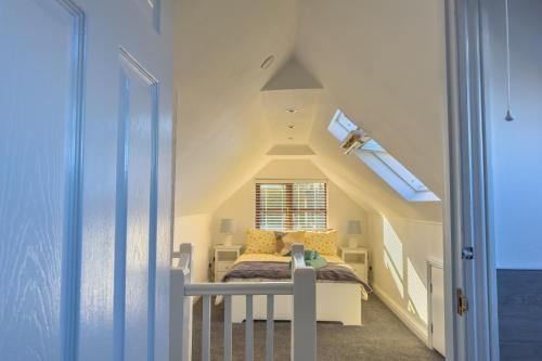 a bedroom with a bed and a window at Snug, Dog Friendly, Country Cottage in Worle