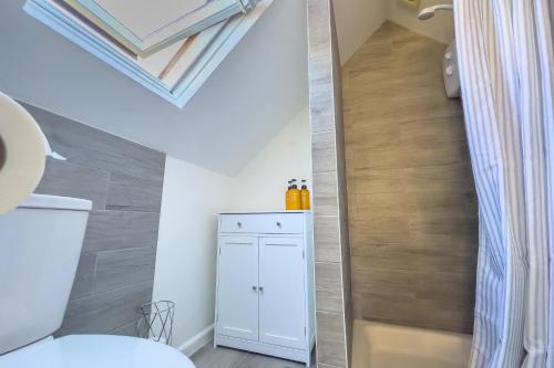 a small bathroom with a white toilet and a staircase at Snug, Dog Friendly, Country Cottage in Worle
