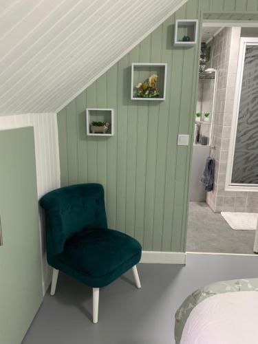 - une chambre avec une chaise verte et un lit dans l'établissement Walnut and Chestnut Gites, à Mauzens-et-Miremont