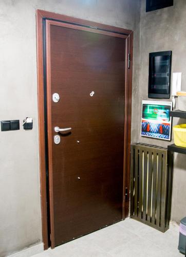 a wooden door in a room with a television at Mikel Angelo hall in Serres