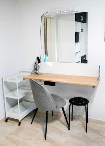 a desk with a chair and a mirror at Mikel Angelo hall in Serres