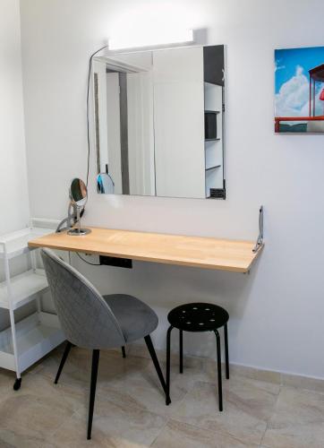 a desk with a chair and a mirror at Mikel Angelo hall in Serres