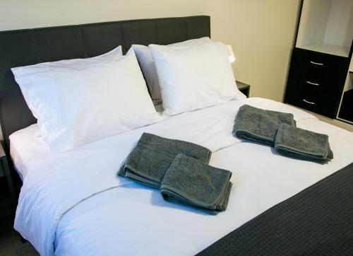 a bed with two towels and two pillows on it at Mikel Angelo hall in Serres