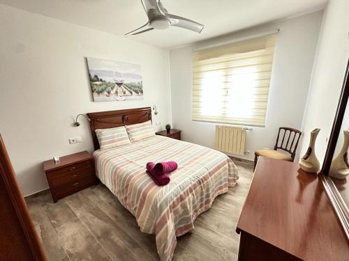 a bedroom with a bed with a pair of shoes on it at Rioja Villa by Wave Properties in Arrúbal