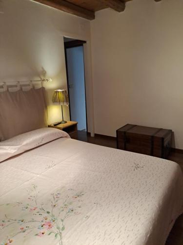 a bedroom with a bed with a white bedspread at A Casa dei Nonni in Frascati