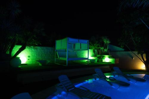a pool with chairs and a house at night at Villa Campito in El Puerto de Santa María