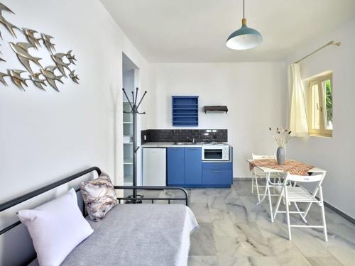 a kitchen with a couch and a table in a room at Villa Maria - Naoussa Pigeons Blue & Gold Suite in Naousa