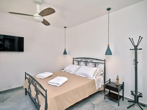 een slaapkamer met een bed met twee handdoeken erop bij Villa Maria - Naoussa Squares Blue & Gold Suite in Naousa