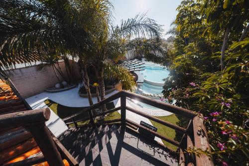 a balcony with a swimming pool and palm trees at Villa Campito in El Puerto de Santa María