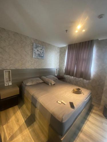 uma cama grande num quarto com em apartement bintaro icon em Kampungutan Dua