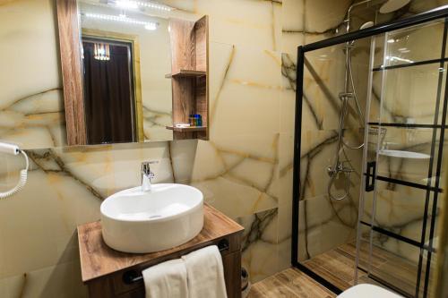 a bathroom with a sink and a shower at Uçhisar Premium in Nevsehir