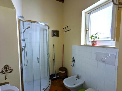 a bathroom with a shower and a toilet and a sink at La Casa Delle Fate in Siracusa