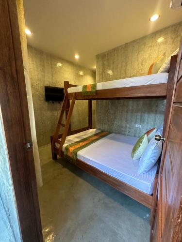 a couple of bunk beds in a room at RL Harbor Inn in El Nido