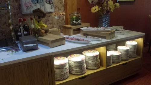 a buffet with plates and cakes on a counter at To Tu in Mrągowo