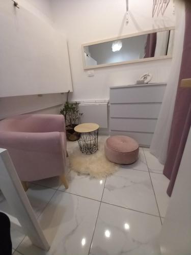 a bathroom with a pink sink and a stool at Barko rooms in Hvar