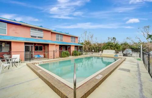 a swimming pool in front of a house at Tiki Retreat in Fort Myers