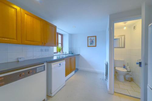 a kitchen with a sink and a toilet at Seaside-Dog Friendly-Country Cottage-w log burner in Worle