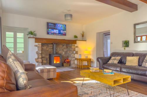 a living room with a couch and a fireplace at Seaside-Dog Friendly-Country Cottage-w log burner in Worle
