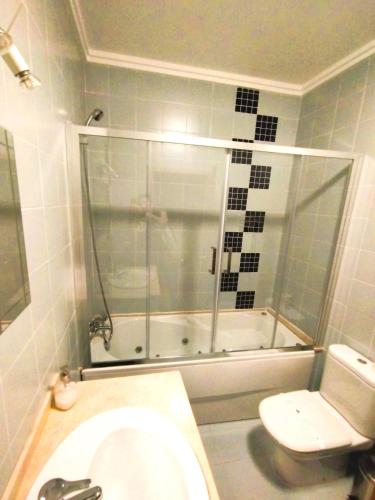 a bathroom with a shower and a toilet and a sink at The Lookout in Areia Branca