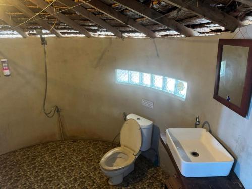 a bathroom with a toilet and a sink at Sunset Beach Bungalow Koh Pu in Ko Jum