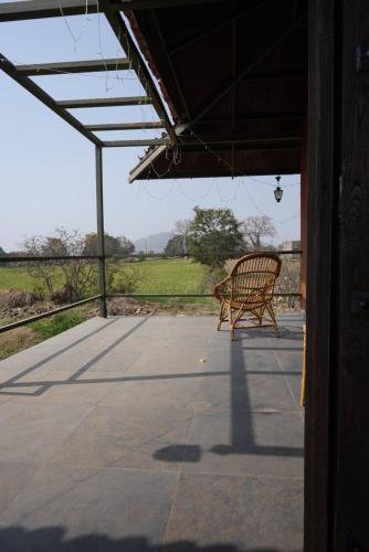 a bench sitting on top of a patio at Khirni House in Māndu