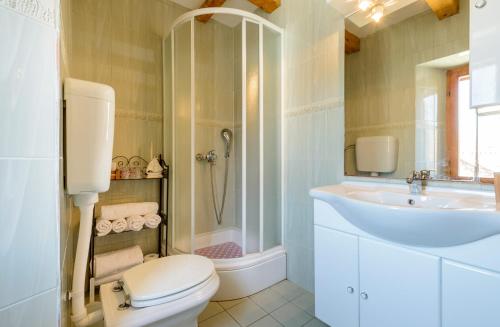 a bathroom with a toilet and a sink and a shower at Vila Donna Apartments in Trogir