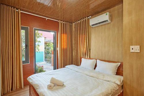 a bedroom with a bed with a towel on it at Khoảnh Khăc Homestay in Vung Tau