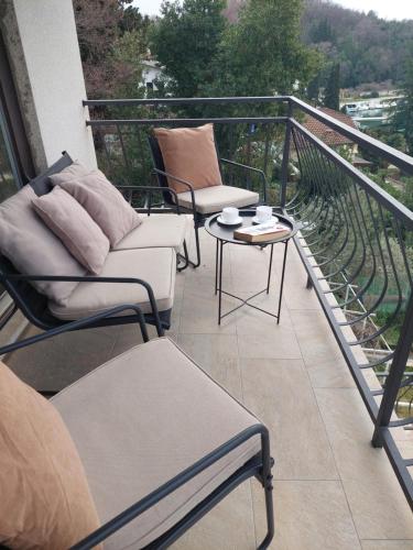 a balcony with two chairs and a table on a balcony at Apartman Marija II in Omišalj