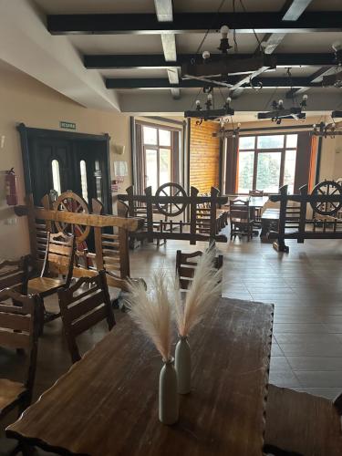 a room with a wooden table with feathers on it at Hincesti Hotel in Hînceşti