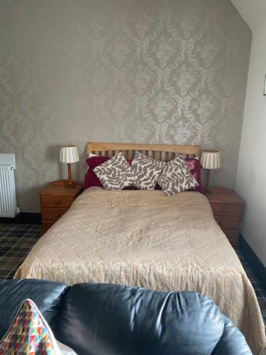a bedroom with a bed with pillows on it at Cromarty View Guest House in Dingwall