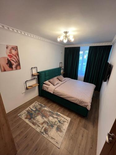 a small bedroom with a bed and a rug at LNB ApartHotel Traian in Constanţa