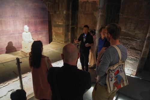 a group of people looking at a statue in a museum at Chengdu Local Tea Hostel - Short Walk To Taikooli - Chill & Social Coffee Lounge - Metro downstairs - Free Activities - Friendly English Speaking Staff - Tibet, Panda, Buddha & Snow Mountain Tours in Chengdu