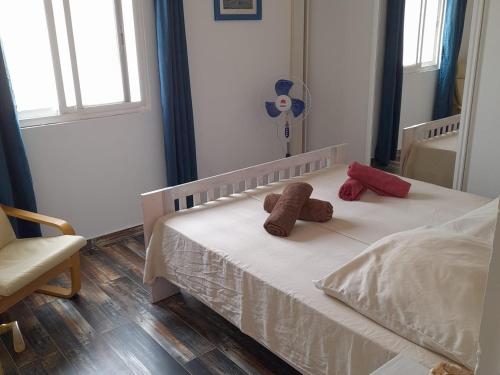 a bedroom with a bed with two teddy bears on it at Pandora Ocean View am Praia Cabral in Sal Rei