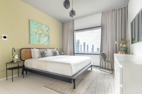 a bedroom with a bed and a large window at Frank Porter - Index Tower in Dubai