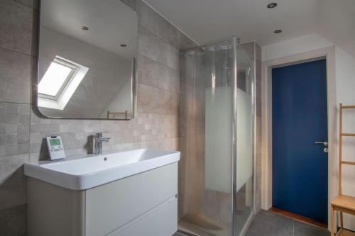 une salle de bain avec un lavabo blanc et une douche dans l'établissement L'Or - Typical Alsacian apartment in Strasbourg, à Strasbourg
