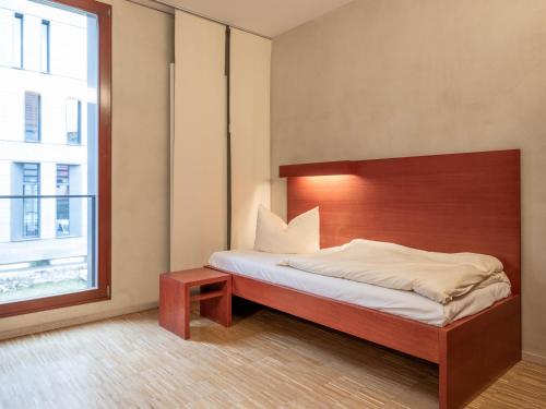 a bedroom with a bed and a large window at Ev. Augustinerkloster zu Erfurt in Erfurt