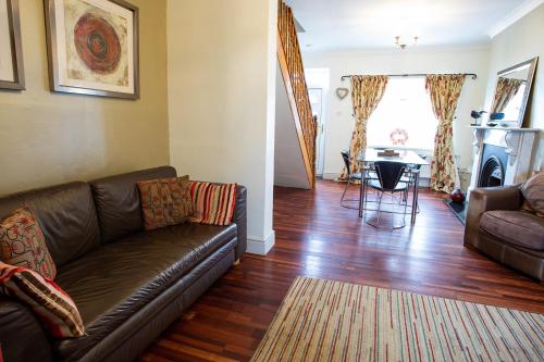 a living room with a couch and a table at Tilly Cottage, DurhamDales in Bishop Auckland
