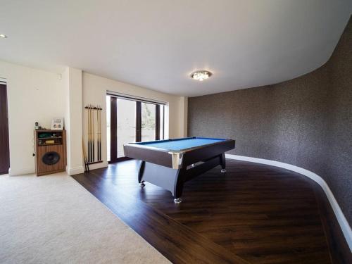 a pool table in the middle of a room at The Pines in Saint Leonards