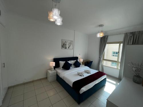 a bedroom with a bed with two stuffed animals on it at Charming 1BR in The Greens, Near Metro in Dubai