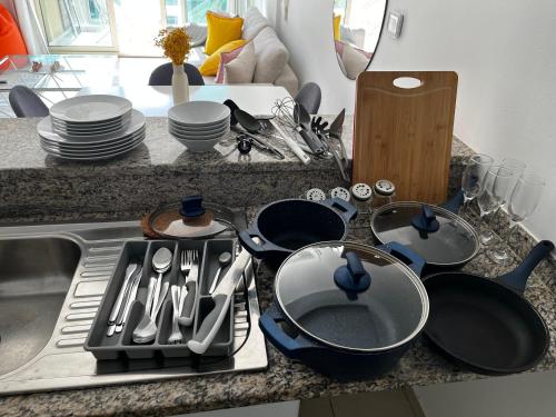 a kitchen counter with pots and pans on a stove at Charming 1BR in The Greens, Near Metro in Dubai