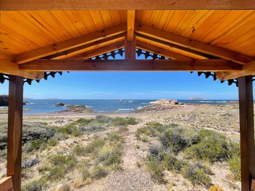 a view of the ocean from the porch of a house at Isla Leones Camps in Camarones