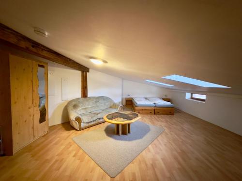 a living room with a couch and a table at Picobello Pension in Görlitz