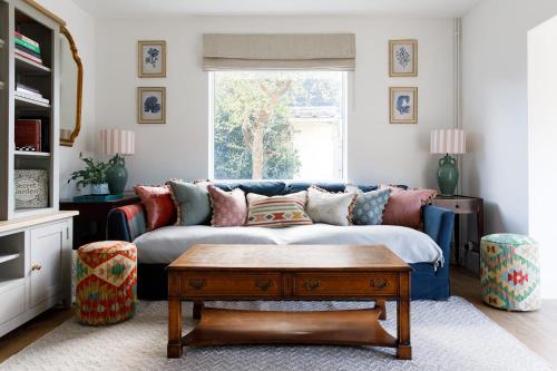 a living room with a couch and a coffee table at Newly Renovated Cottage 150m from Waterfront in Bosham
